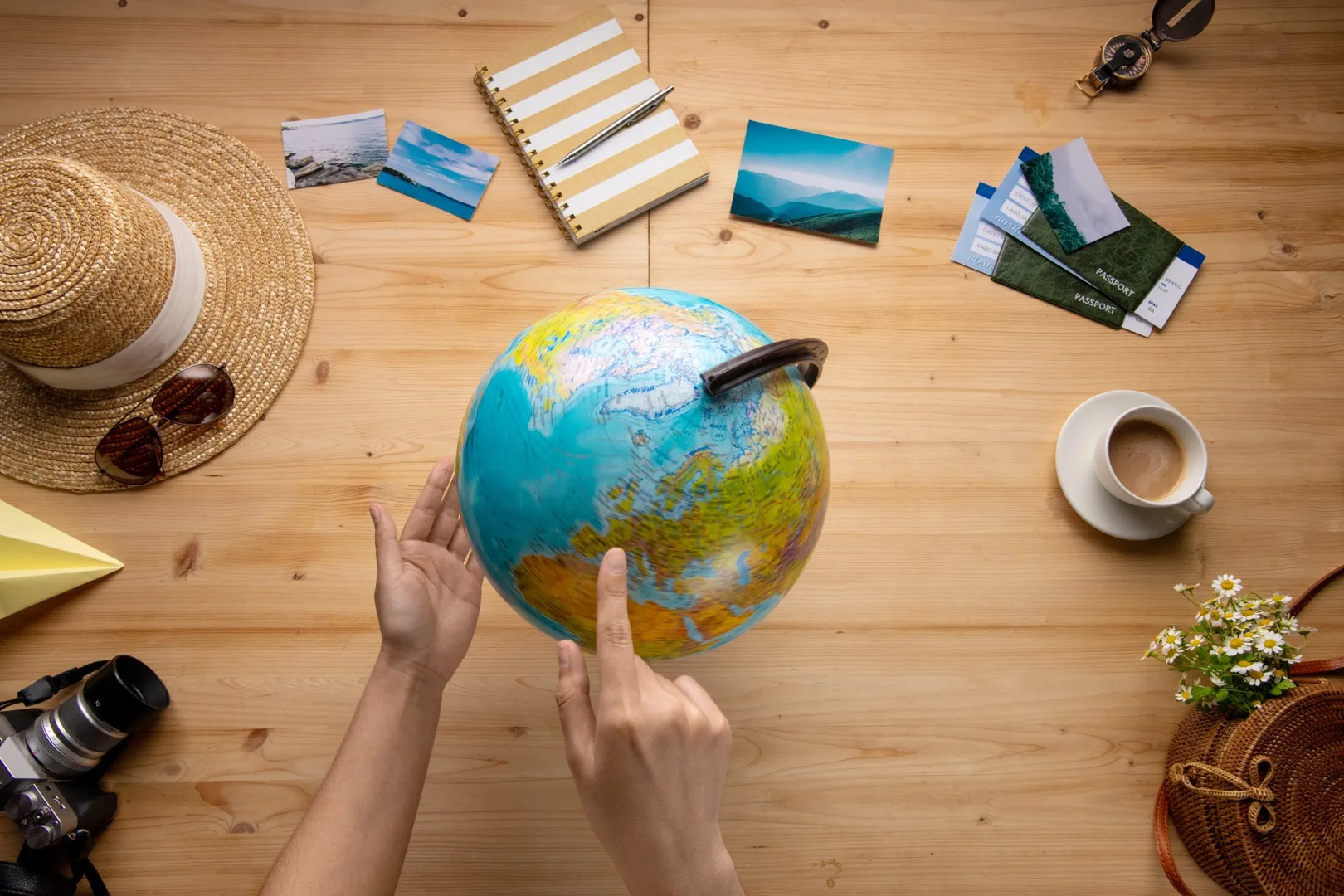 Person examining a world map while planning a remote work relocation