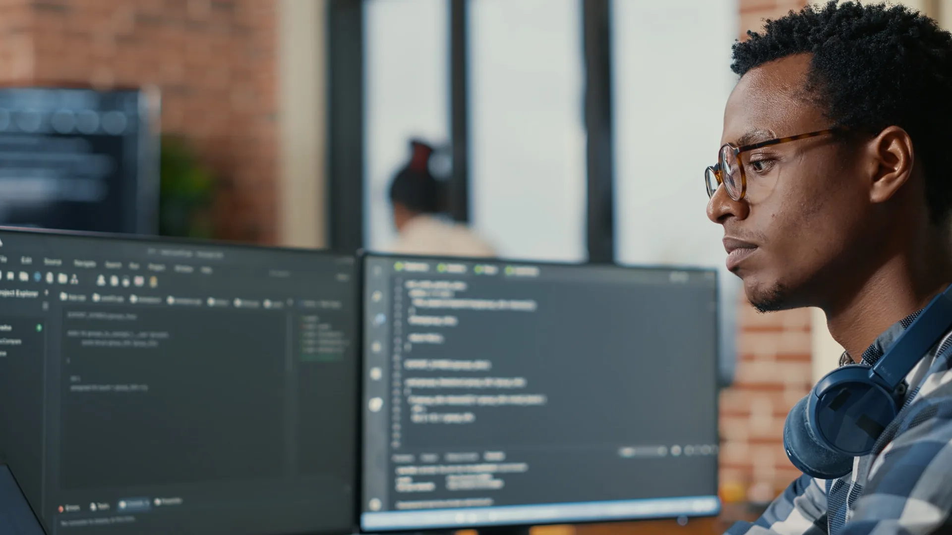 Software developer writing code on a laptop screen in focused work environment