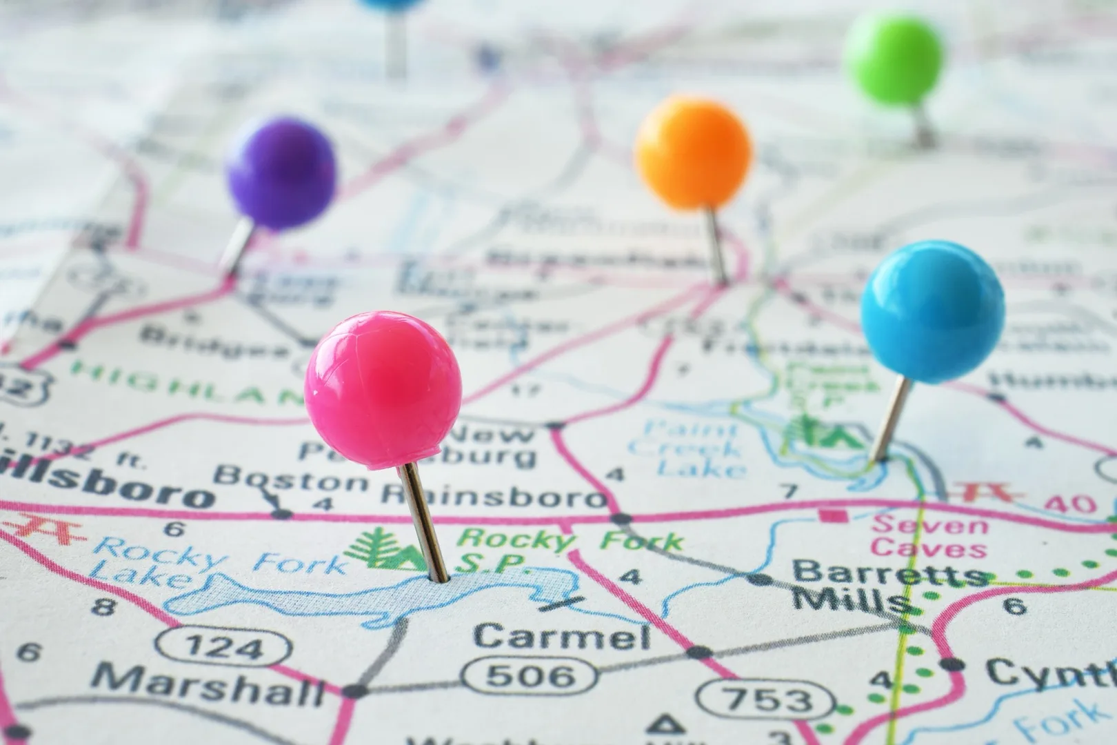 Detailed map with colorful pushpins marking cities where tech salaries go furthest