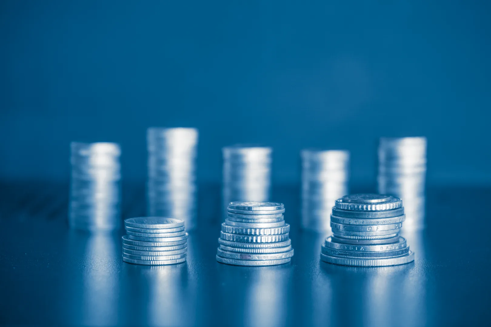 Stack of coins representing salary comparison across cities