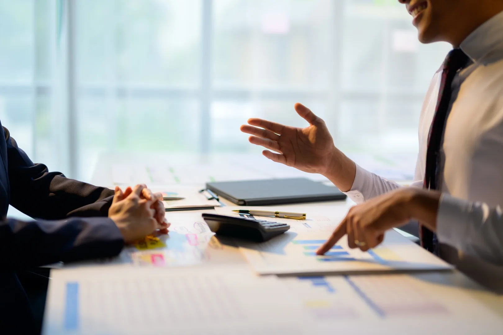Business team analyzing salary transparency data and financial charts at a conference table