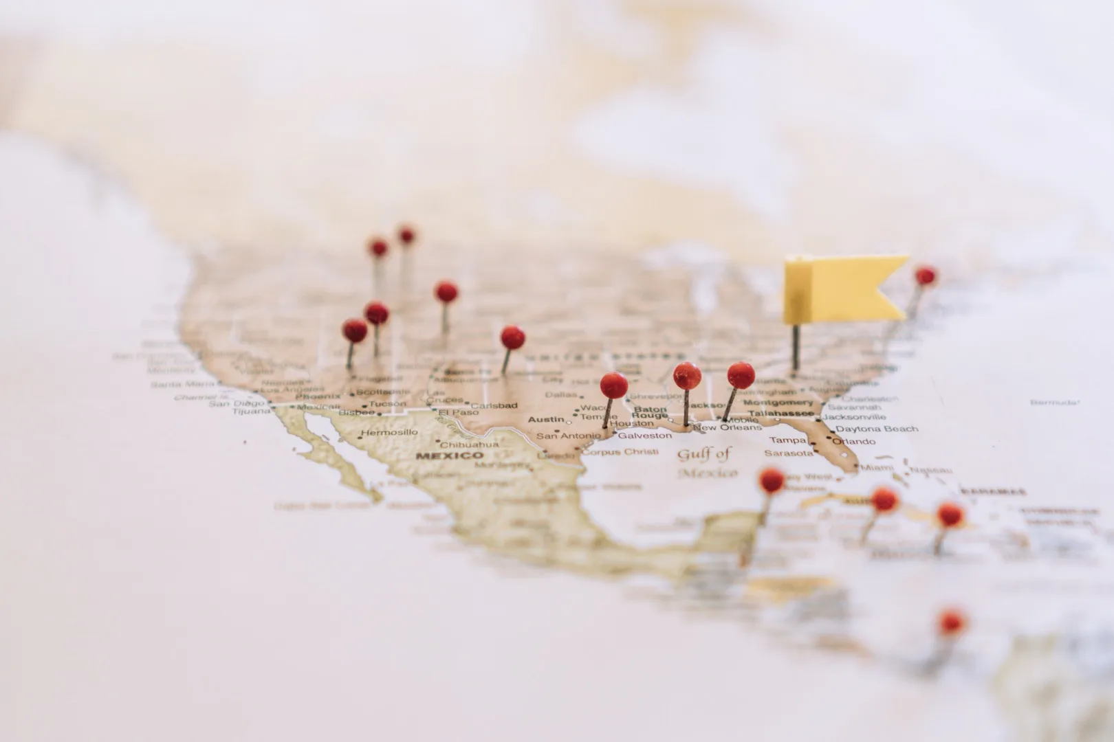 Map of the United States with colorful pins marking tech hub cities and H-1B visa salary data